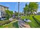 Charming backyard with lush landscaping, walkway, and tropical palm trees at 8940 Park Blvd # 8940A, Seminole, FL 33777