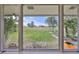 Scenic backyard view through windows with a well manicured golf course and blue skies at 8940 Park Blvd # 8940A, Seminole, FL 33777