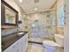 Bathroom features a frameless glass shower, designer vanity, and tiled walls at 8940 Park Blvd # 8940A, Seminole, FL 33777
