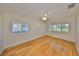 Bright bedroom with hardwood floors, three windows, and a ceiling fan at 8940 Park Blvd # 8940A, Seminole, FL 33777