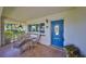 Cozy front porch with seating, an oval blue door, and decorative features for relaxing at 8940 Park Blvd # 8940A, Seminole, FL 33777