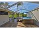 Hot tub on a screened patio, overlooking a manicured lawn at 8940 Park Blvd # 8940A, Seminole, FL 33777
