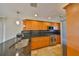 Bright kitchen featuring custom wood cabinets, stainless steel appliances, and granite countertops at 8940 Park Blvd # 8940A, Seminole, FL 33777