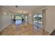 Bright living room with travertine floors, ample natural light, and outdoor views at 8940 Park Blvd # 8940A, Seminole, FL 33777