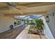 Relaxing covered patio featuring wood-look tile, a hot tub, and serene garden views at 8940 Park Blvd # 8940A, Seminole, FL 33777