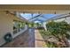 Charming screened patio with lush landscaping, pavers, and a hot tub for outdoor enjoyment at 8940 Park Blvd # 8940A, Seminole, FL 33777