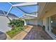 Spacious covered patio area with pavers, lush plants, and clear views of the surrounding property at 8940 Park Blvd # 8940A, Seminole, FL 33777