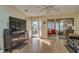 Living room with tile floors, ceiling fan and view of sunroom at 9232 Golf View Dr, New Port Richey, FL 34655