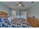 Light and airy main bedroom with tile floors, ceiling fan, and ensuite bathroom at 9232 Golf View Dr, New Port Richey, FL 34655