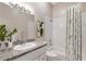 Well-lit bathroom showcasing a vanity with a sink and a shower-tub combo with a patterned curtain at 9808 62Nd N Ter # 9808, St Petersburg, FL 33708