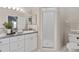 Bathroom featuring a modern vanity, granite countertops, and a glass-enclosed shower for convenience and style at 9808 62Nd N Ter # 9808, St Petersburg, FL 33708