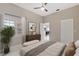 Relaxing bedroom featuring natural light, an ensuite bathroom, and a dresser for storage and style at 9808 62Nd N Ter # 9808, St Petersburg, FL 33708