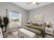 Comfortable bedroom featuring a ceiling fan, stylish decor, and an inviting bed with a bench at 9808 62Nd N Ter # 9808, St Petersburg, FL 33708