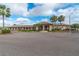 Community clubhouse with covered walkways, mature landscaping, and water feature at 9808 62Nd N Ter # 9808, St Petersburg, FL 33708