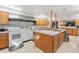 Community kitchen with stainless steel appliances, center island and ample cabinet space at 9808 62Nd N Ter # 9808, St Petersburg, FL 33708