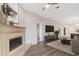 Features a fireplace, mounted TV, wood flooring and neutral decor throughout the living space at 9808 62Nd N Ter # 9808, St Petersburg, FL 33708