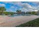 Inviting community pool with lake view, lounge seating, and umbrellas at 9808 62Nd N Ter # 9808, St Petersburg, FL 33708