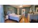 Bright bedroom with light hardwood floors, neutral paint, and a comfortable bed, creating a relaxing and welcoming atmosphere at 11204 Pembridge Ct # 5, Port Richey, FL 34668
