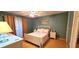 Comfortable bedroom with hardwood floors, a ceiling fan, a neutral color scheme, and ample natural light for a serene ambiance at 11204 Pembridge Ct # 5, Port Richey, FL 34668