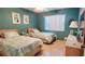 Inviting bedroom featuring two twin beds with coordinated bedding, complemented by natural light streaming through the window at 11204 Pembridge Ct # 5, Port Richey, FL 34668