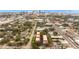 Enjoy an aerial view of low-rise apartments nestled among verdant trees with the backdrop of a stunning urban skyline at 111 N Albany Ave # 3, Tampa, FL 33606