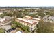 Charming low-rise condos with brick-tiled roofs, surrounded by lush trees, near a parking lot, with views of the cityscape at 111 N Albany Ave # 3, Tampa, FL 33606