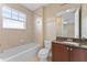 Bright bathroom featuring a shower over tub and granite vanity counter at 111 N Albany Ave # 3, Tampa, FL 33606