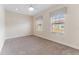 Neutral colored carpeted bedroom with ceiling fan and two windows at 111 N Albany Ave # 3, Tampa, FL 33606