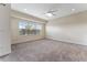 Large bedroom with neutral carpeting, ceiling fan, and large windows at 111 N Albany Ave # 3, Tampa, FL 33606