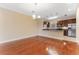 Dining area with hardwood floors adjacent to kitchen with stainless steel appliances at 111 N Albany Ave # 3, Tampa, FL 33606