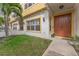 Inviting townhouse entrance with a warm-toned door, manicured lawn, and stylish architectural details at 111 N Albany Ave # 3, Tampa, FL 33606