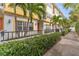 Beautiful townhouse exterior featuring vibrant yellow accents, lush green landscaping, and a charming pathway at 111 N Albany Ave # 3, Tampa, FL 33606