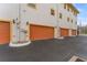 Exterior view showing private garages and yellow accented architectural details at 111 N Albany Ave # 3, Tampa, FL 33606