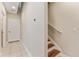 Bright hallway with tile flooring, leading to a staircase with wooden steps and white railing at 111 N Albany Ave # 3, Tampa, FL 33606