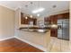 Open concept kitchen with granite countertops and dark wood cabinetry at 111 N Albany Ave # 3, Tampa, FL 33606