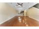 Open concept living room with hardwood floors, ceiling fan, and recessed lighting flowing into the kitchen at 111 N Albany Ave # 3, Tampa, FL 33606