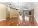 Spacious open-plan living room with beautiful wood floors, recessed lighting, and stairs to the upper level at 111 N Albany Ave # 3, Tampa, FL 33606