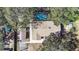 Overhead view of the home showcasing the roof, pool area, and surrounding landscape with mature trees at 1122 S Mulrennan Rd, Valrico, FL 33594