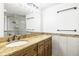 Bathroom with honey marble countertops and dual shower head behind glass doors at 1122 S Mulrennan Rd, Valrico, FL 33594