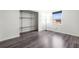 Empty bedroom features modern floors and a closet with metal shelves and hardware at 1122 S Mulrennan Rd, Valrico, FL 33594