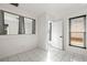 Bright bedroom with tiled floors, two windows, and white trim at 1122 S Mulrennan Rd, Valrico, FL 33594