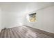 Bright bedroom with gray wood-look floors and a large window at 1122 S Mulrennan Rd, Valrico, FL 33594