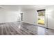 Spacious living room features modern floors and two windows overlooking the yard at 1122 S Mulrennan Rd, Valrico, FL 33594