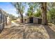 View of a detached shed in backyard that is ideal for storage or a workshop, complemented by mature trees at 1122 S Mulrennan Rd, Valrico, FL 33594