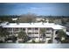 Aerial view of a well-maintained complex with lush landscaping and a beautiful blue sky backdrop at 11620 Park Blvd # 308, Seminole, FL 33772