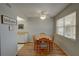 Cozy dining area features a wood table, four chairs, and natural light from a nearby window at 11620 Park Blvd # 308, Seminole, FL 33772