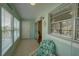 Enclosed lanai provides a relaxing space with a comfortable chair and views of the surrounding landscape at 11620 Park Blvd # 308, Seminole, FL 33772