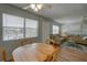 Cozy living and dining space with a large window, ceiling fan, and comfortable seating at 11620 Park Blvd # 308, Seminole, FL 33772