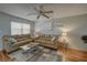 Inviting living room features two sofas, a ceiling fan, and a large window for natural light at 11620 Park Blvd # 308, Seminole, FL 33772