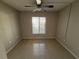 Empty bedroom with tile flooring and a central window at 1179 Pine Ridge Cir W # A1, Tarpon Springs, FL 34688